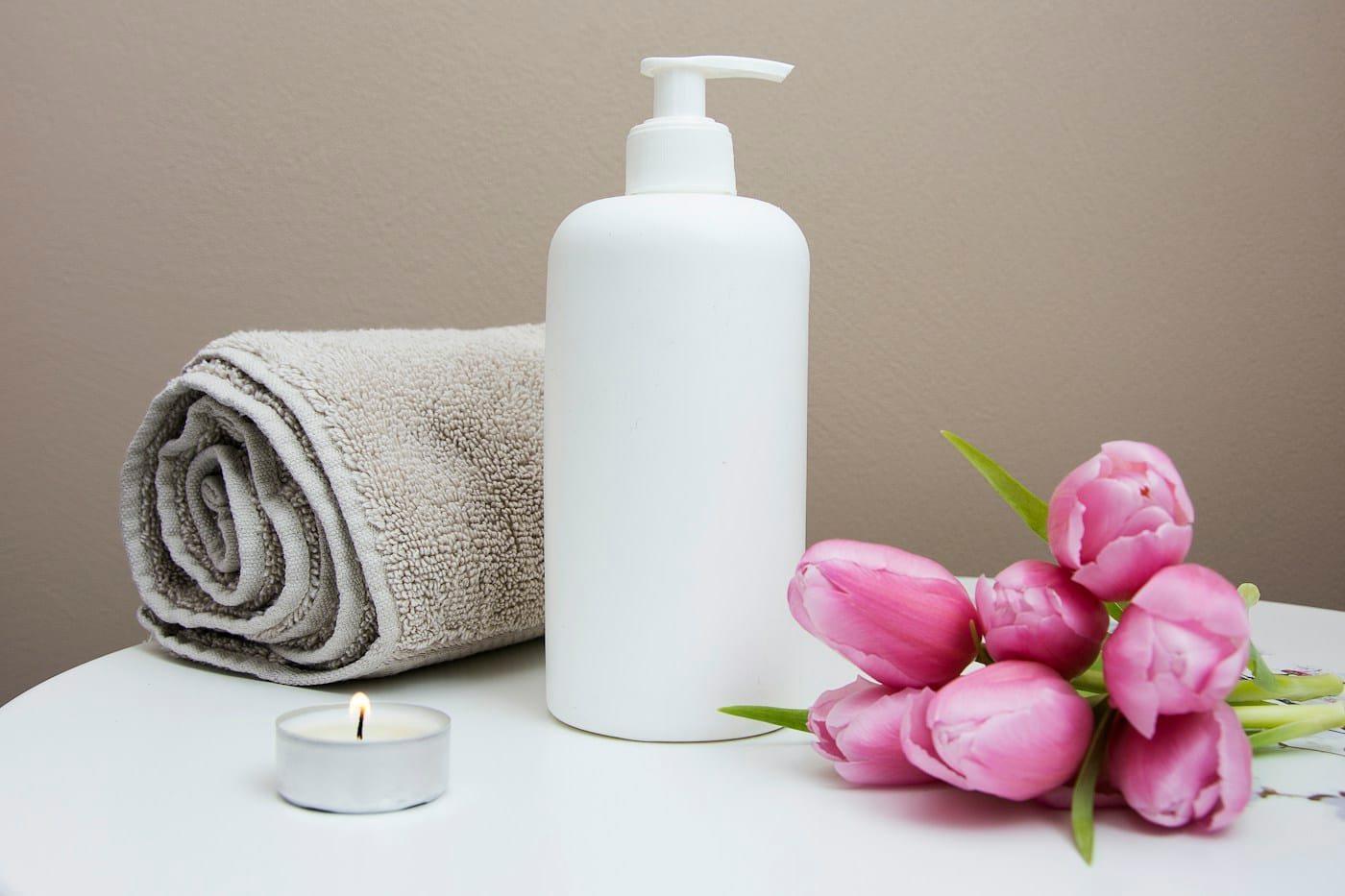 Spa still-life — towel, candle and flowers