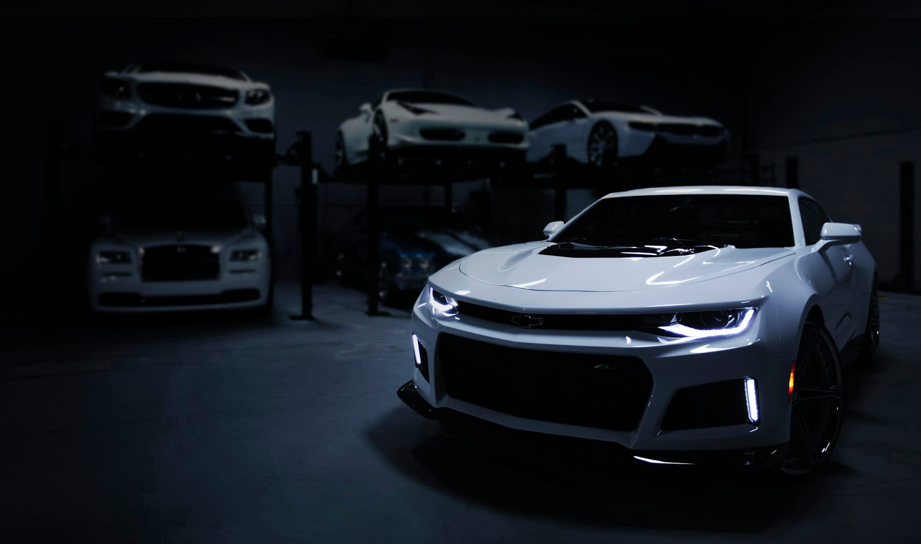 A vehicle emerging into light in the Noiré studio